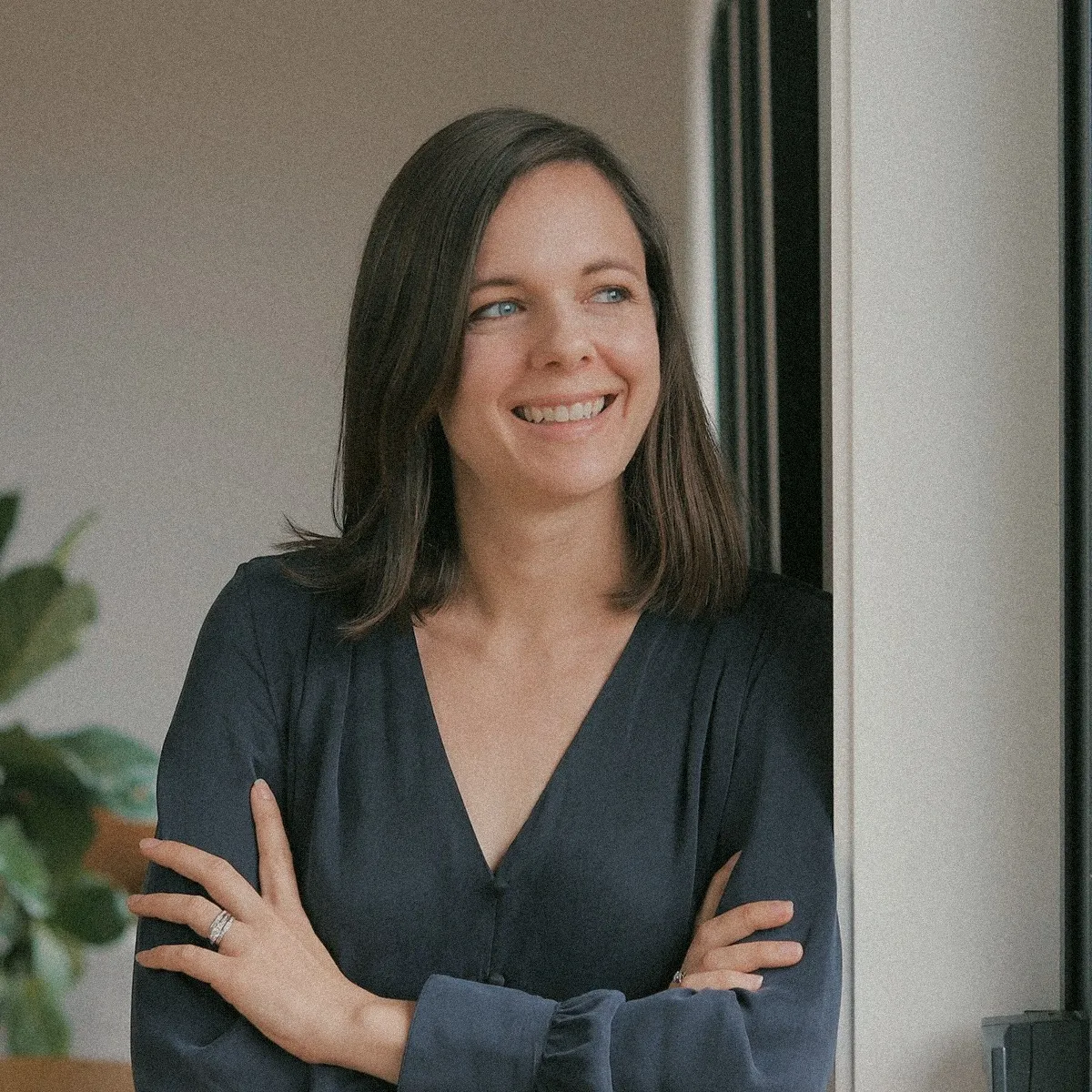 Charlotte Ellis smiling with arms crossed